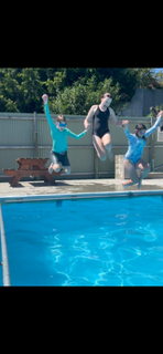 Kids jumping into the pool together