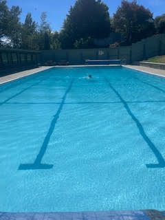 Swimmer in the Cust Community Pool on a summer day