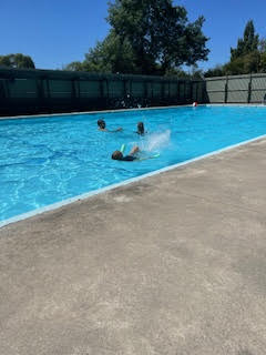 Kids splashing and swimming in the Cust pool